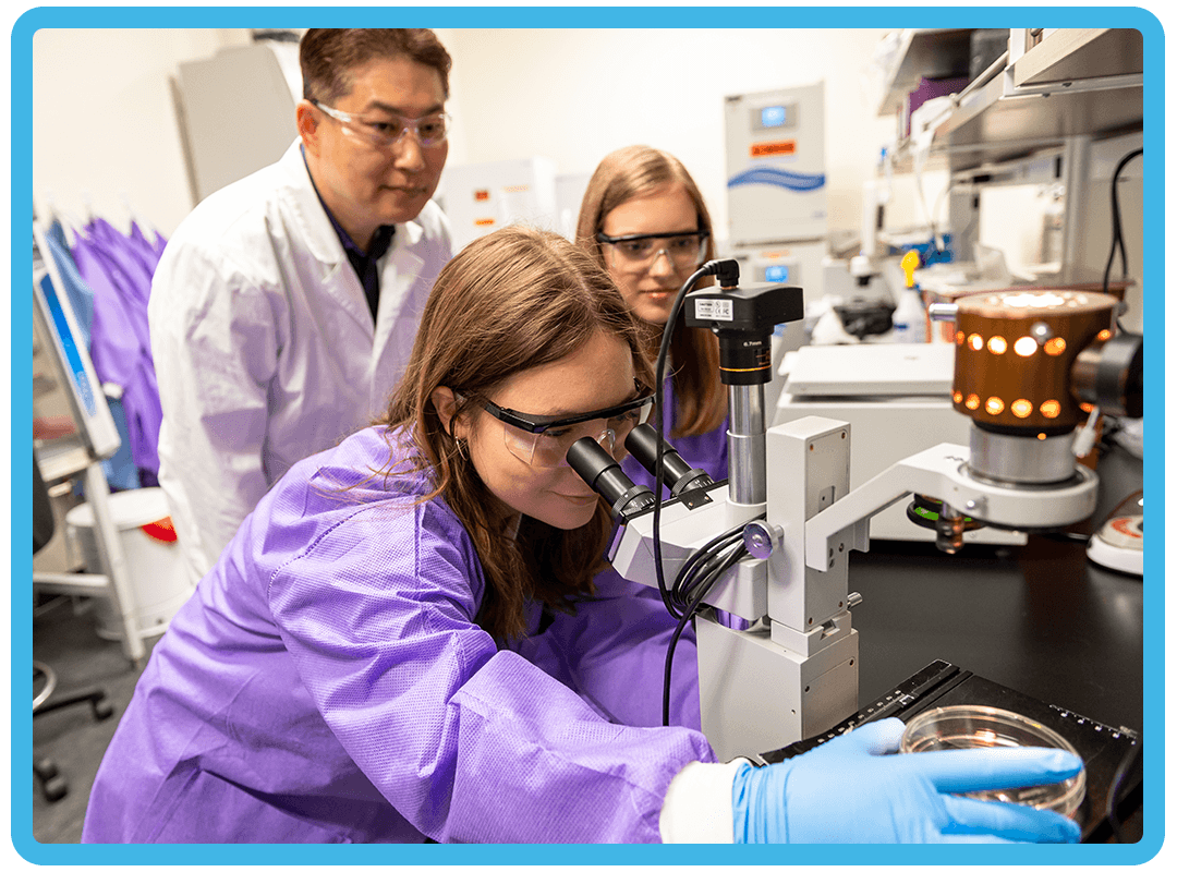 Students and professor doing an experiment.